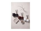 Scented candles and reed diffusers in Sandalwood & Oud, Wild Rose, and White Musk.
