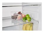 Clear fridge organizer with tomatoes, peaches, and limes, bananas below.