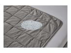 A gray quilted weighted blanket with a magnified view of the glass beads inside.