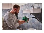 Man using a drain cleaning tool to clear a clogged sink drain in a bathroom.