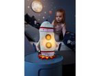A Playtive rocket night light illuminates a child's bedroom.