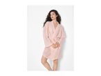 Woman with dark curly hair wearing a light pink short bathrobe