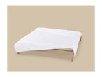 White quilted mattress protector on a wooden bed frame.