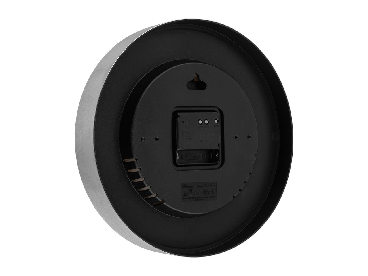 Back view of a round wall clock with a brushed metal frame and battery compartment.