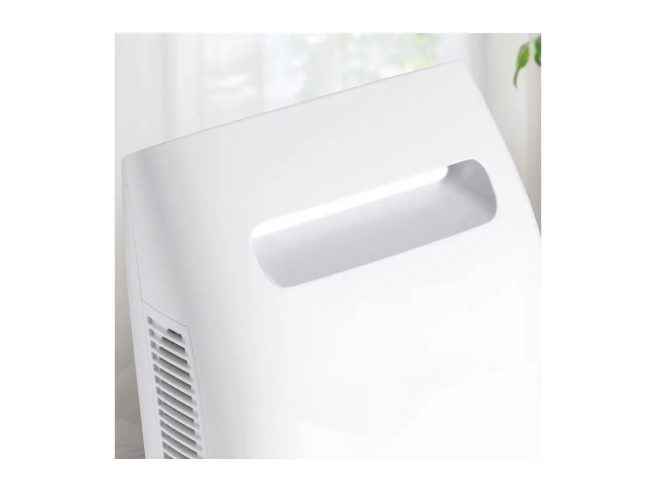 Close-up of a white dehumidifier with a built-in carrying handle.