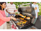 Friends grilling burgers, chicken, and vegetables on a Grillmeister 4 Burner Gas Barbecue.