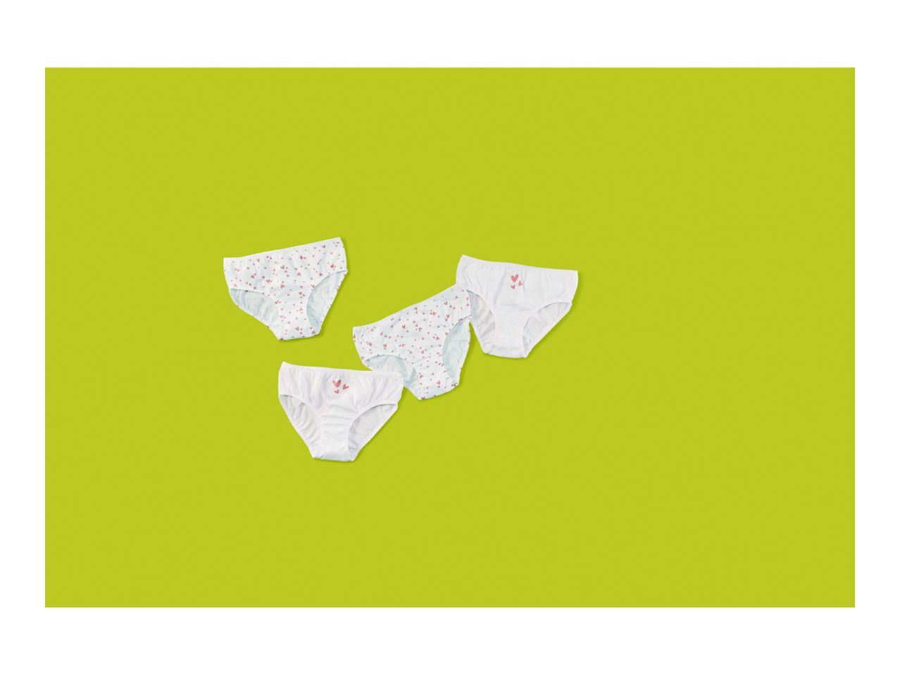 Four pairs of children's briefs, two white with hearts, two white with small hearts.