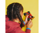 Girl with braids playing with a red toy race car.