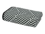 Folded towel with a black and white geometric pattern