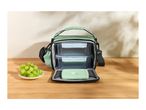 Green lunch bag with two food containers and a separate ice pack, next to a plate of grapes.