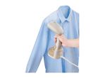 Handheld garment steamer used on a light blue shirt