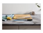 A blue ceramic sharpening rod on a kitchen counter next to a cutting board and lemons.