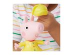 Child holding a pink pig toy in a yellow raincoat, wearing a striped t-shirt.