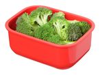 Fresh broccoli florets in a red rectangular container.