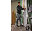 Man wearing Parkside® S1P Safety Shoes while preparing a door for painting.