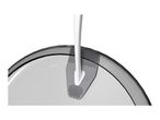 Close-up of a white and gray kitchen utensil with a textured surface, resting on a clear bowl.