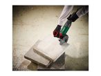 A person using a Parkside angle grinder to cut a concrete slab.