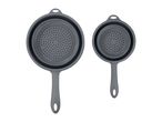 A set of two collapsible silicone colanders in gray.