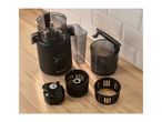 Black food processor with various attachments on a wooden surface.