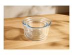 Three clear glass nesting bowls on a wooden surface with shadows