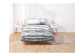 Grey and blue striped bedding on a bed.