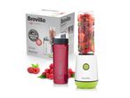 Personal blender with a bottle full of berries, a spare bottle, and its packaging.