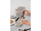 Beige Bergner espresso machine with a glass of milk.