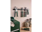 Parkside tools, including pliers and hole punches, hanging on a wall in a workshop setting.