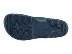 Bottom view of a dark blue shoe sole with a green insert and textured grip.