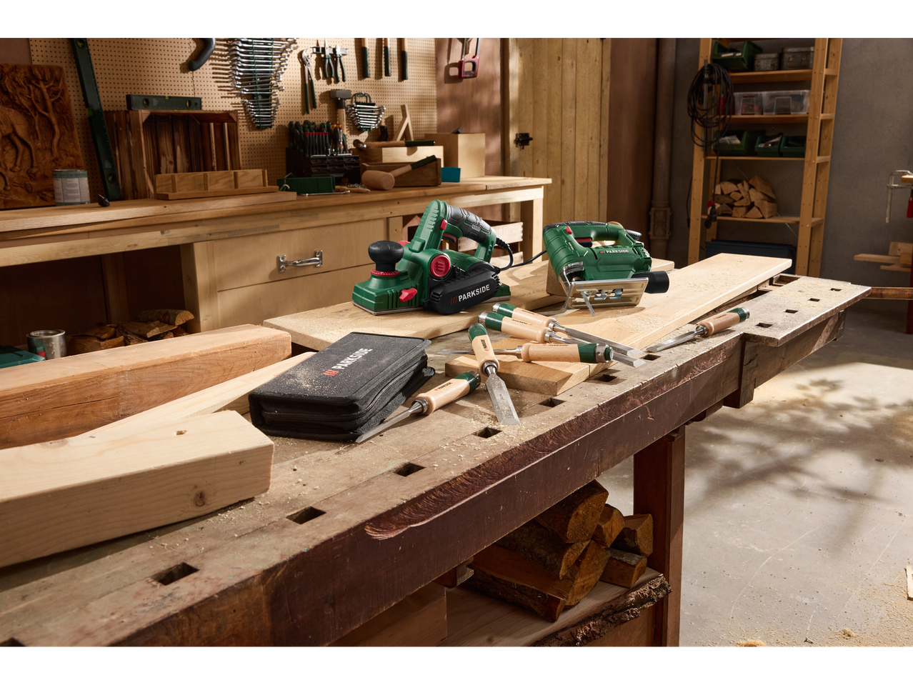 Woodworking tools: electric planer, jigsaw, and chisels on a wooden workbench.