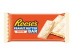 White chocolate peanut butter bar in an orange wrapper, with a broken bar showing the filling.