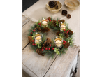 LIVARNO home Christmas Wreath with pinecones, red berries, and four lit candles on a wooden table.