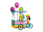 Toy ice cream bike with a girl minifigure, featuring colorful lollipops and dispensers.