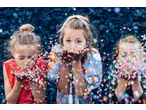 Three LUPILU girls blowing colorful confetti, smiling and joyful.