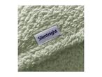 Close-up of a soft, light green fleece blanket with a white label featuring dark blue text.