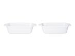 Two white rectangular ceramic baking dishes with ribbed sides and small handles