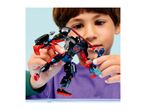 A child playing with a black and red robot toy, holding a small blue figure.