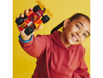Smiling girl holds a red toy race car in her hand.