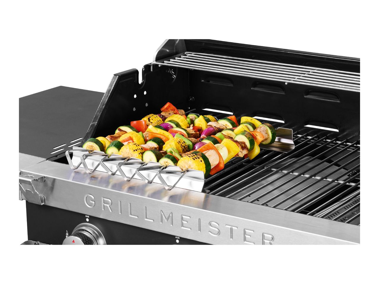 Gas grill with vegetable and meat skewers on a kebab rack, featuring a stainless steel control panel.