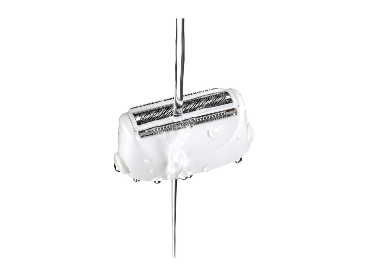 White electric shaver head being rinsed under running water, showing water droplets.