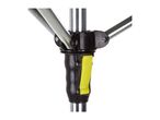 Close-up of a black and yellow plastic joint connecting silver metal poles.