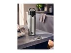 Stainless steel water bottle on a kitchen counter next to keys and a notebook.