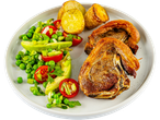 A plate of roasted lamb chops served with roasted potatoes and a fresh pea and avocado salad.