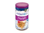 Souvlaki seasoning in a shaker, with a Greek-themed label showing grilled chicken skewers.