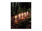Six star-shaped garden lights illuminate a mulched garden bed with green shrubs.