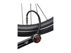 A Crivit bicycle pump with a gauge is shown inflating a bicycle tire.