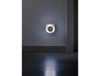 LIVARNO home LED Night Light plugged into a wall socket, illuminating a dark room.