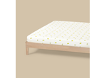 Livarno Jersey Fitted Sheet with a lemon pattern on a wooden bed frame.