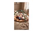 Baby lying on a brown playmat with a green activity arch and hanging toys.