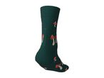 Dark green sock with a red and white mushroom pattern